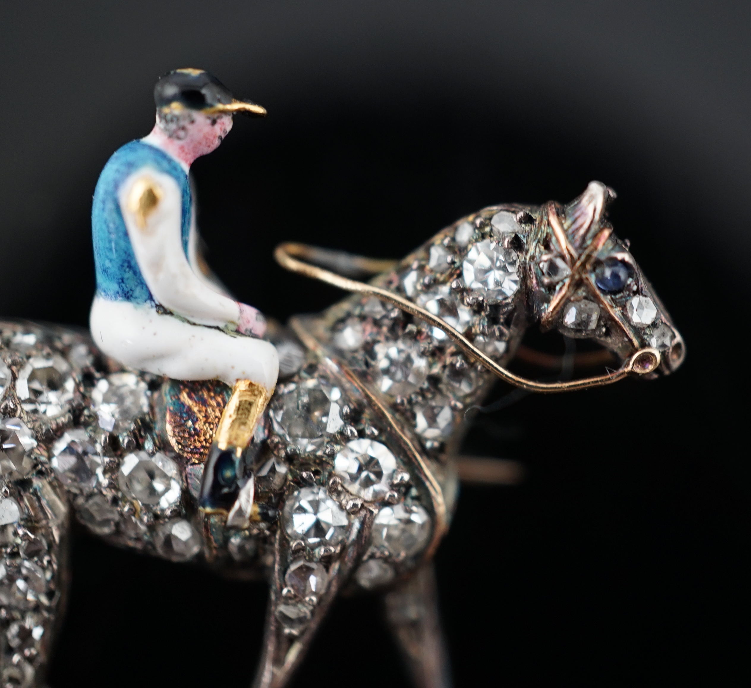 A late Victorian gold, rose cut diamond and polychrome enamel set horse and jockey brooch